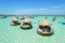 Floating tiki boat bars on turquoise water at Crab Island
